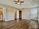 A bright, airy bedroom boasts a tray ceiling, ceiling fan, and doorways to other rooms at 6008 Grassy Knoll Cir, Matthews, NC 28104