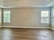 Large bedroom featuring light walls, wood flooring and ample natural light from a row of windows at 6008 Grassy Knoll Cir, Matthews, NC 28104