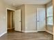 Empty bedroom with wood-look flooring and multiple doors at 6008 Grassy Knoll Cir, Matthews, NC 28104
