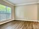 Bright bedroom with wood-look flooring and large window at 6008 Grassy Knoll Cir, Matthews, NC 28104