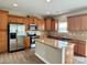 Modern kitchen with stainless steel appliances, granite countertops, and an island at 6008 Grassy Knoll Cir, Matthews, NC 28104