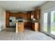An eat-in kitchen with stainless steel appliances, wooden cabinets, and granite countertops with an island at 6008 Grassy Knoll Cir, Matthews, NC 28104