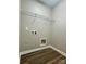 Laundry room with overhead shelving and utility connections at 6008 Grassy Knoll Cir, Matthews, NC 28104