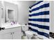 Bathroom featuring blue and white striped shower curtain and white vanity at 6359 Mallard View Ln, Charlotte, NC 28269