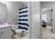 Bathroom featuring blue and white striped shower curtain and white vanity at 6359 Mallard View Ln, Charlotte, NC 28269