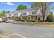 Townhouse complex featuring well-manicured landscaping, ample parking, and classic brick and siding accents at 6359 Mallard View Ln, Charlotte, NC 28269
