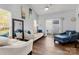 Bright living room featuring hardwood floors, neutral-colored sofas and a ceiling fan at 6359 Mallard View Ln, Charlotte, NC 28269