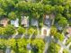 A high angle view displays the rooftops and tree canopies of homes lining a neighborhood street at 6741 Stillmeadow Dr, Charlotte, NC 28277