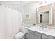 Bright bathroom featuring white vanity with framed mirror and shower with white curtain at 6741 Stillmeadow Dr, Charlotte, NC 28277