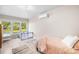 Cozy bedroom with light-colored walls and wood-look flooring, along with a window offering a pleasant outdoor view at 6741 Stillmeadow Dr, Charlotte, NC 28277