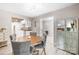 Cozy dining area adjacent to a modern white kitchen, with wood-look floors and views to the office space at 6741 Stillmeadow Dr, Charlotte, NC 28277