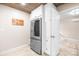 Bright kitchen space with stainless steel refrigerator and white pantry cabinets at 6741 Stillmeadow Dr, Charlotte, NC 28277