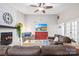 Inviting living room with stone fireplace, plush seating, and a modern ceiling fan at 6741 Stillmeadow Dr, Charlotte, NC 28277