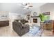 Open-concept living room with a stone fireplace and comfortable furnishings at 6741 Stillmeadow Dr, Charlotte, NC 28277