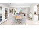 Open-concept living area with French doors, fireplace, hardwood floors, and views to the dining and kitchen areas at 6741 Stillmeadow Dr, Charlotte, NC 28277
