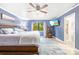 Serene primary bedroom with large windows, soft rug, and blue accent wall at 6741 Stillmeadow Dr, Charlotte, NC 28277