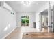 Bright office space with light-colored walls and wood-look flooring and view to fenced backyard through sliding glass doors at 6741 Stillmeadow Dr, Charlotte, NC 28277