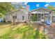 This home shows a screened in porch, a ladder to the roof, and a small section of yard at 6741 Stillmeadow Dr, Charlotte, NC 28277