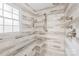 Modern shower with tiled walls, a built-in bench, and sleek fixtures at 6741 Stillmeadow Dr, Charlotte, NC 28277