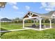 Seating area in a large, well-manicured backyard with green grass and mature landscaping at 7130 Irongate Dr, Indian Land, SC 29707