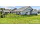 Home featuring a well manicured backyard with lush green grass, a seating area and privacy fence at 7130 Irongate Dr, Indian Land, SC 29707