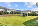 A large well manicured backyard featuring a brick retaining wall, metal fence and covered seating area at 7130 Irongate Dr, Indian Land, SC 29707