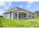 Charming single-Gathering home with covered patio and a well manicured backyard with lush green grass at 7130 Irongate Dr, Indian Land, SC 29707