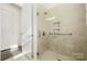 Modern bathroom featuring a glass enclosed shower with tiled walls and a built in shower caddy at 7130 Irongate Dr, Indian Land, SC 29707
