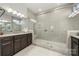 Modern bathroom with a glass-enclosed shower, double vanity, and neutral color palette at 7130 Irongate Dr, Indian Land, SC 29707