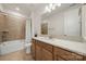 Well-lit bathroom featuring a granite countertop, wood cabinets, and a tiled shower/tub combo at 7130 Irongate Dr, Indian Land, SC 29707
