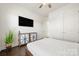 Comfortable bedroom featuring hardwood floors, a modern TV, and ample storage space with stylish cabinets at 7130 Irongate Dr, Indian Land, SC 29707