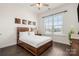 Charming bedroom showcasing hardwood floors, a stylish wooden bed frame, and ample natural light at 7130 Irongate Dr, Indian Land, SC 29707