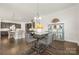 Bright dining area with modern table set, stylish light fixture, and open access to the kitchen at 7130 Irongate Dr, Indian Land, SC 29707
