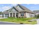Beautiful home showcasing the lush lawn, stone accents, and complementary siding on a sunny day at 7130 Irongate Dr, Indian Land, SC 29707