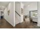 Inviting hallway showcasing hardwood floors, staircase, and open flow to dining and living areas at 7130 Irongate Dr, Indian Land, SC 29707