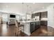 Bright kitchen features a center island with marble accents, stainless appliances, and open access to the living room at 7130 Irongate Dr, Indian Land, SC 29707