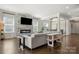 Spacious living room with a modern fireplace, large windows, and an open floor plan at 7130 Irongate Dr, Indian Land, SC 29707