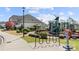 A community playground with a slide, climbing equipment, and lush landscaping at 7130 Irongate Dr, Indian Land, SC 29707