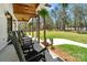 Spacious covered porch with rocking chairs overlooking a sprawling lawn and wooded area at 722 Clegg Farm Dr, York, SC 29745