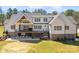 Expansive backyard featuring a covered deck, outdoor seating, and a beautifully landscaped lawn at 722 Clegg Farm Dr, York, SC 29745