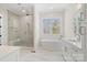 Bright bathroom with a glass-enclosed shower, soaking tub, double vanity and a large window at 722 Clegg Farm Dr, York, SC 29745