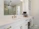 Bright bathroom vanity featuring white countertops, a gold faucet, and a large frameless mirror reflecting the shower at 722 Clegg Farm Dr, York, SC 29745