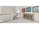 Light-filled hallway with staircase and a charming cabinet, connecting different areas of the home at 722 Clegg Farm Dr, York, SC 29745