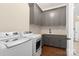 Well-equipped laundry room with modern washer and dryer units, complemented by custom cabinets and wood countertops at 722 Clegg Farm Dr, York, SC 29745