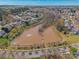 An aerial view of a neighborhood featuring a large body of water and green surroundings at 7554 Coastal Way, Huntersville, NC 28078