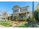 Inviting two-story home with a well-manicured lawn, blossoming shrubs, and a cozy front porch at 7554 Coastal Way, Huntersville, NC 28078