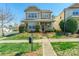 Charming two-story home with landscaped front yard and inviting entrance on a sunny day at 7554 Coastal Way, Huntersville, NC 28078