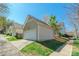 Exterior of garage with white door and siding with green space on a sunny day at 7554 Coastal Way, Huntersville, NC 28078