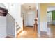 Inviting hallway with hardwood floors, staircase, and natural light, leading to the home's entrance at 7554 Coastal Way, Huntersville, NC 28078