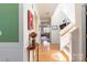 Bright hallway with hardwood floors, staircase, and elegant decor, offering a warm welcome at 7554 Coastal Way, Huntersville, NC 28078